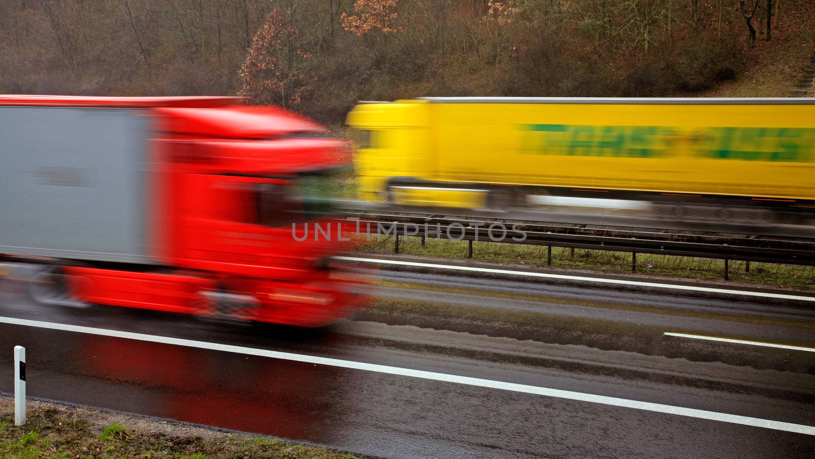 Two colorful trucks driving on the German Autobahn