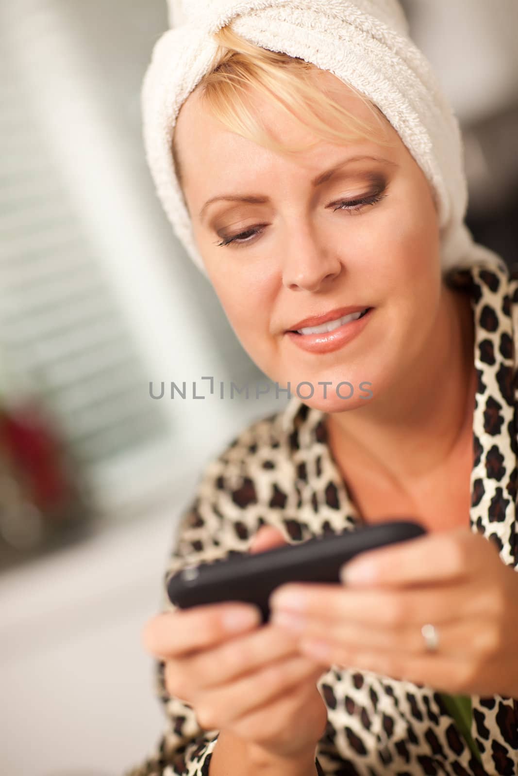 Attractive Woman Texting With Her Cell Phone with Narrow Depth of Field.