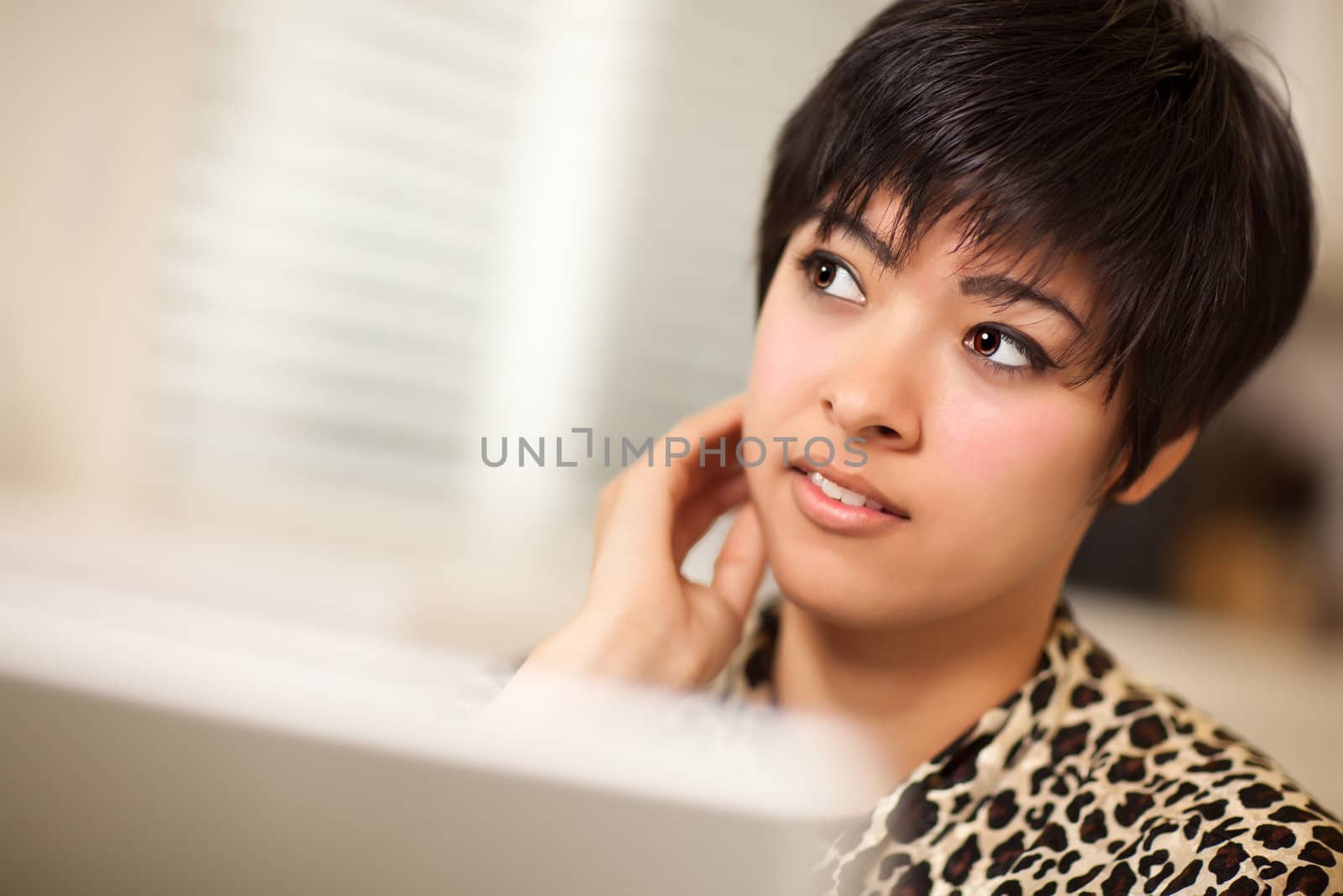 Pretty Smiling Multiethnic Woman Using Her Laptop Computer.