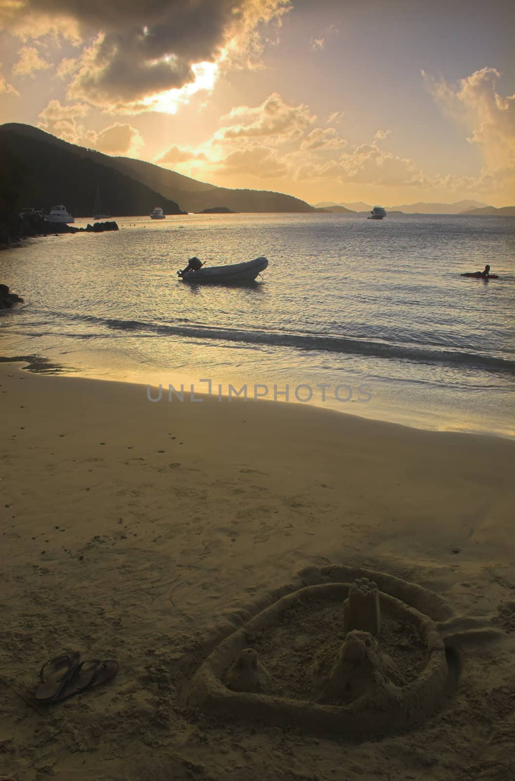 Sunset on a beach with a sand castle