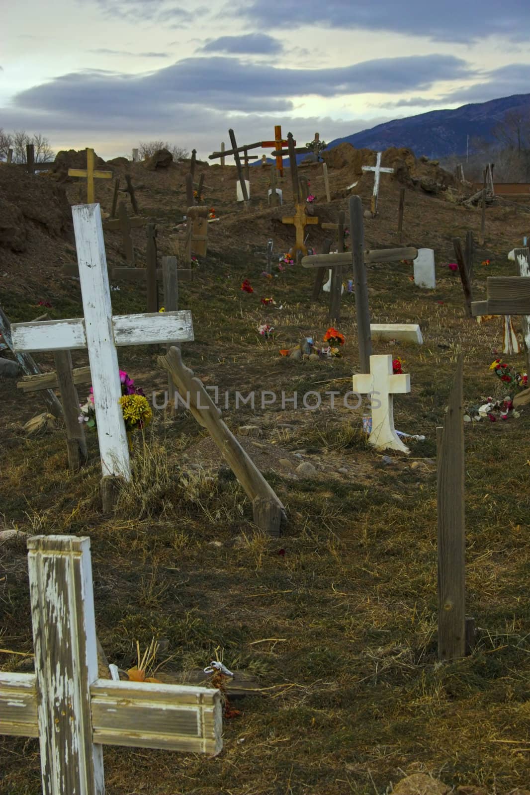 Old cemetery with white crosses and evening sky