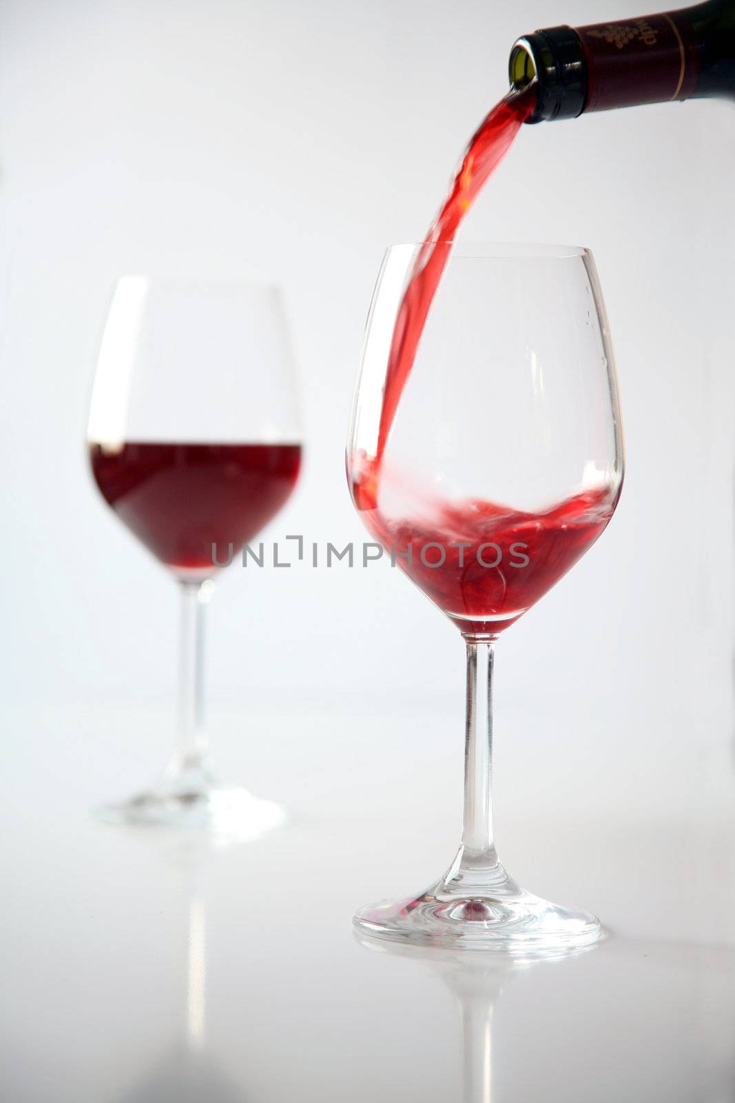 Two glasses of red wine and bottle
