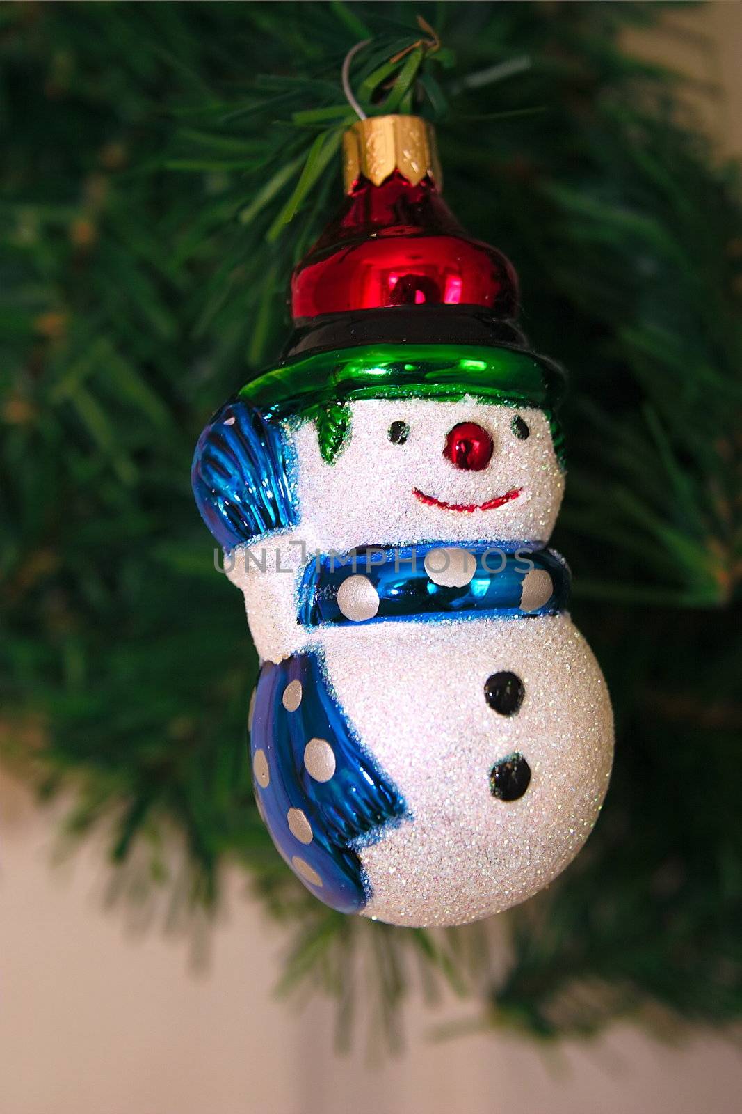 snowman ornament hanging on the christmas tree