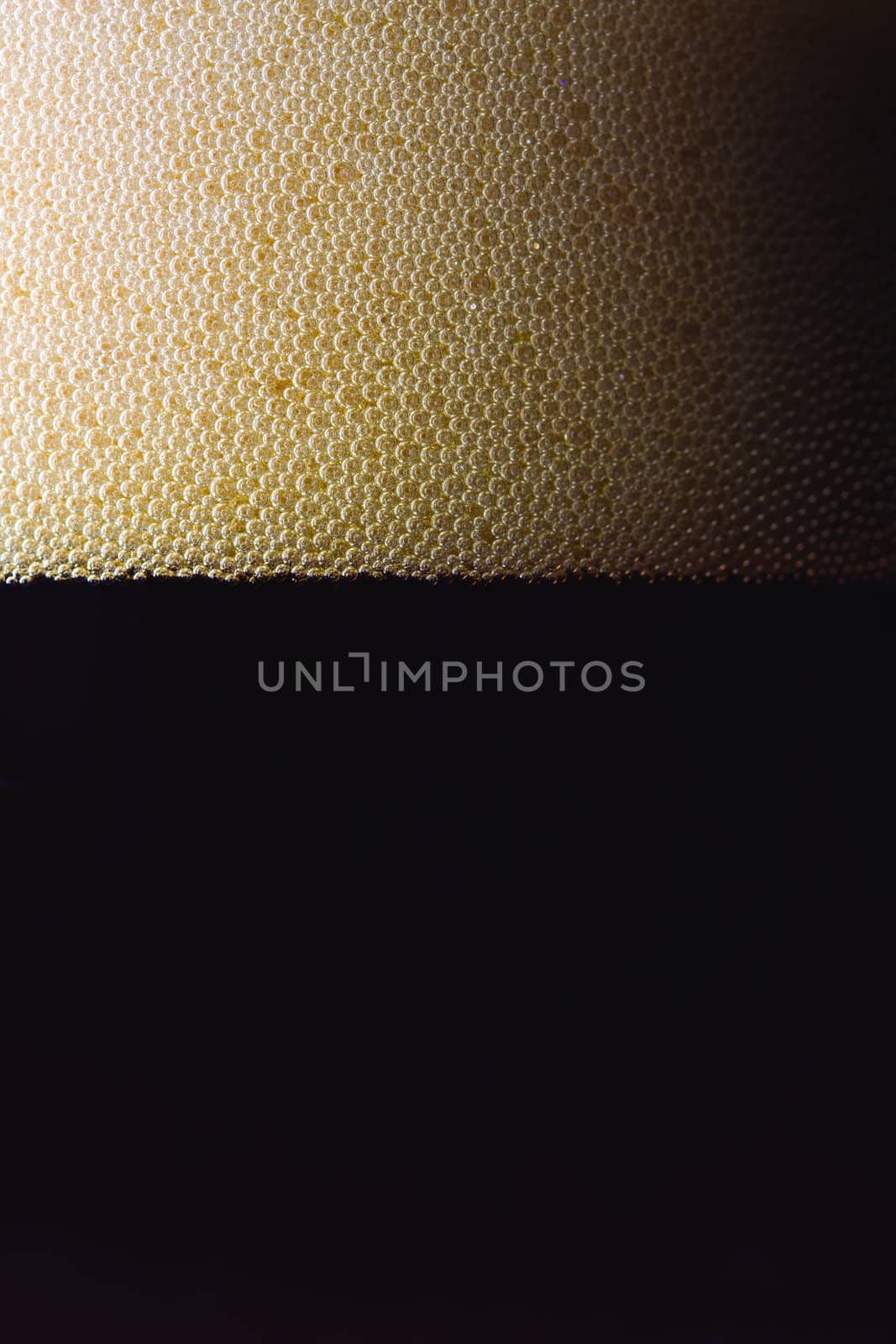 bubbles of dark beer in a glass by bernjuer