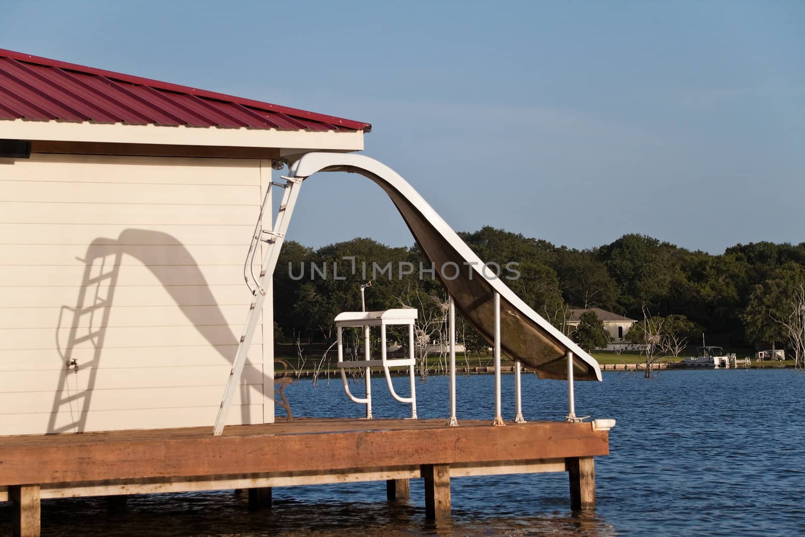 A waterslide on the end of a wooden dock