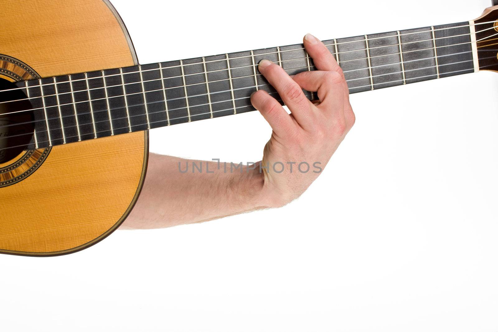 male hand holding a chord on a classsical guitar