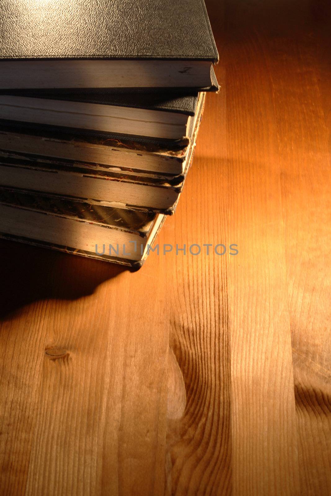 Stack of very old books lying on wooden background