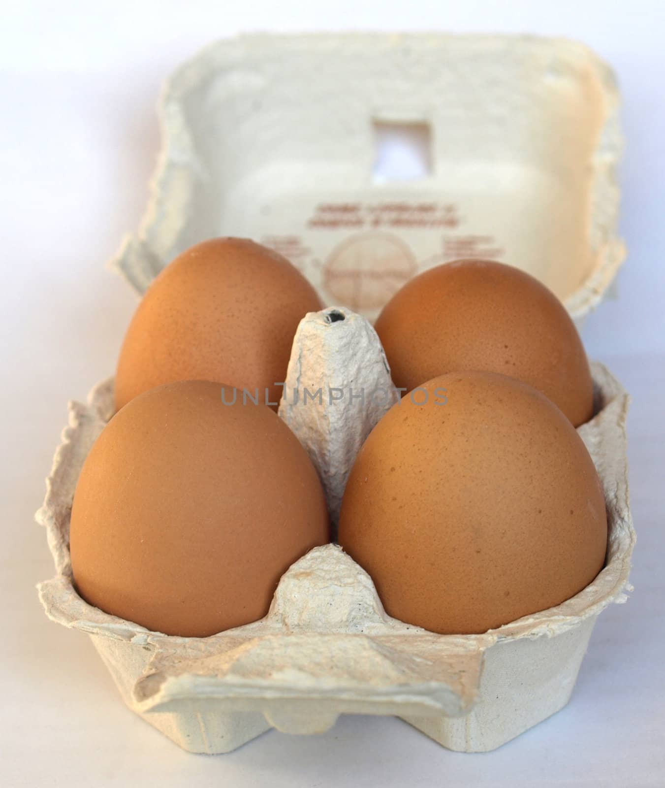 Four eggs in a cardboard wrap box