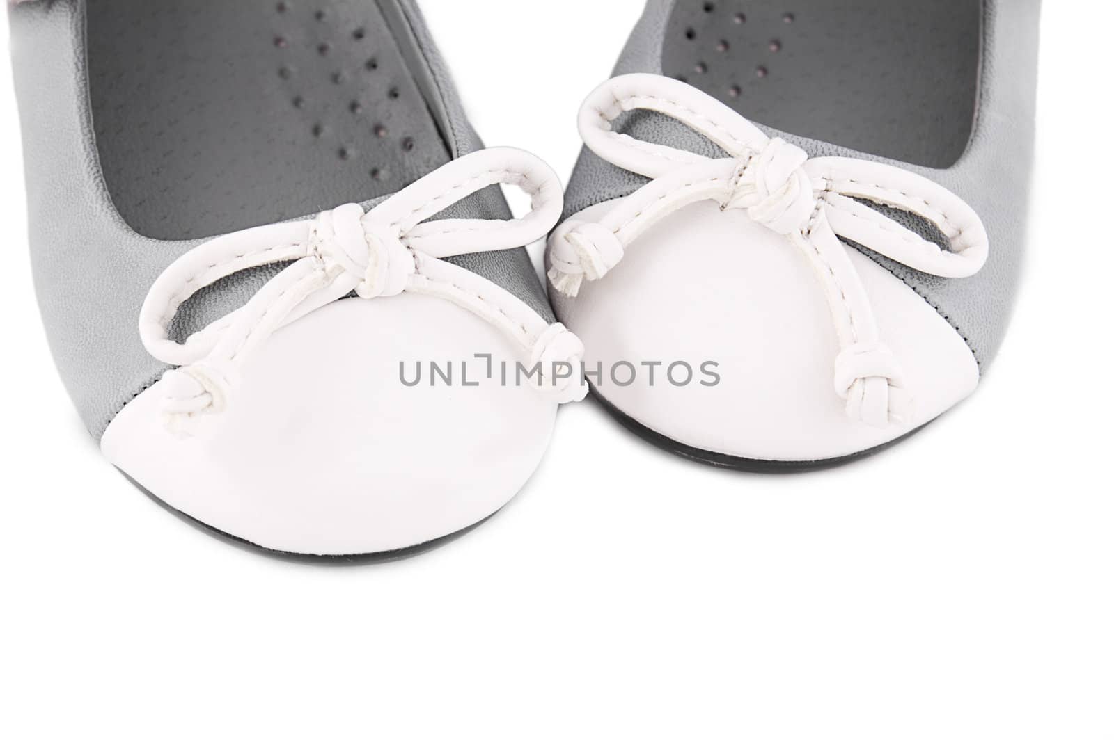Pair of gray and white baby shoes with bows