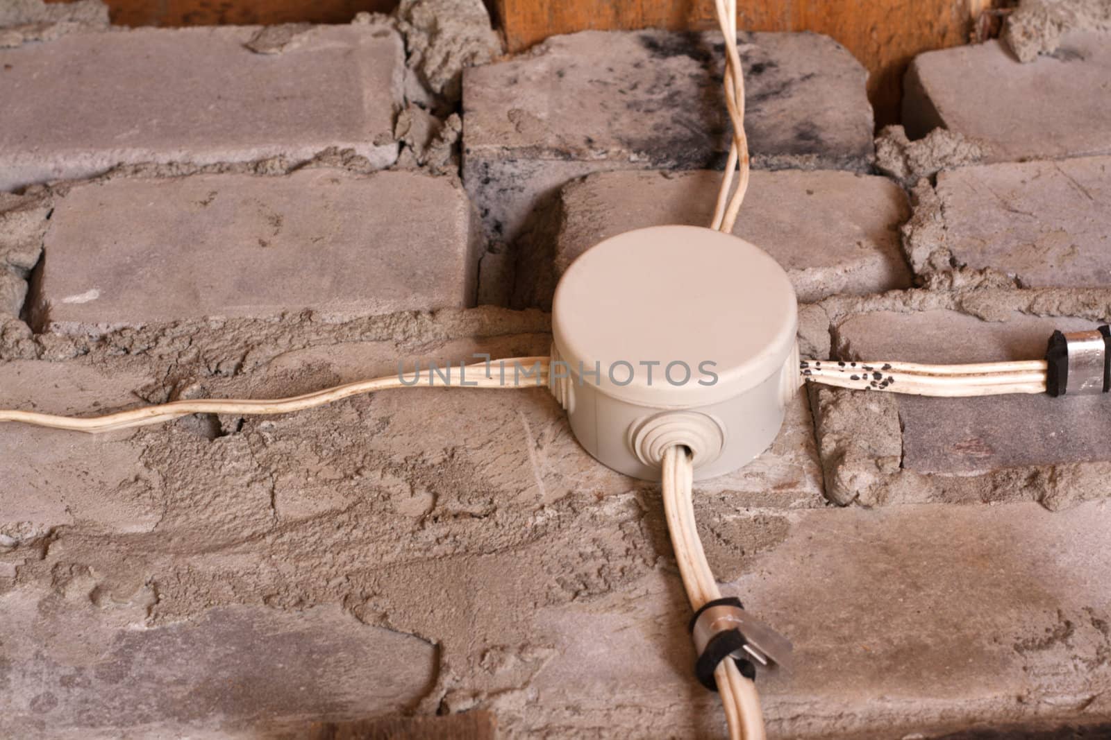 Electric connecting box, wire on brick wall