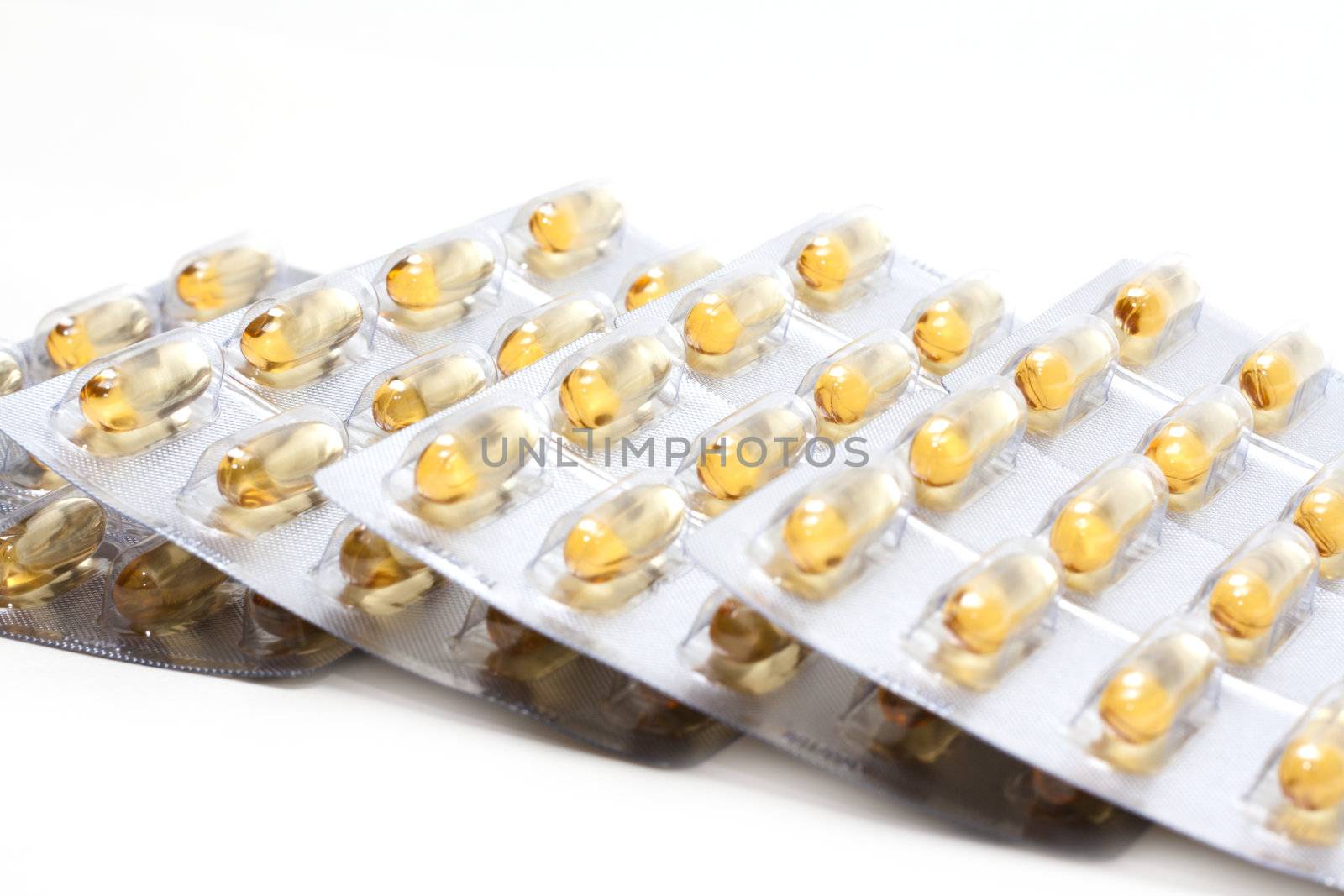 Packing the capsules cod-liver oil, insulated on white background