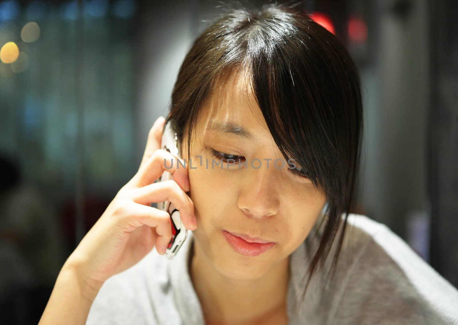 woman talking on the phone in restaurant by leungchopan