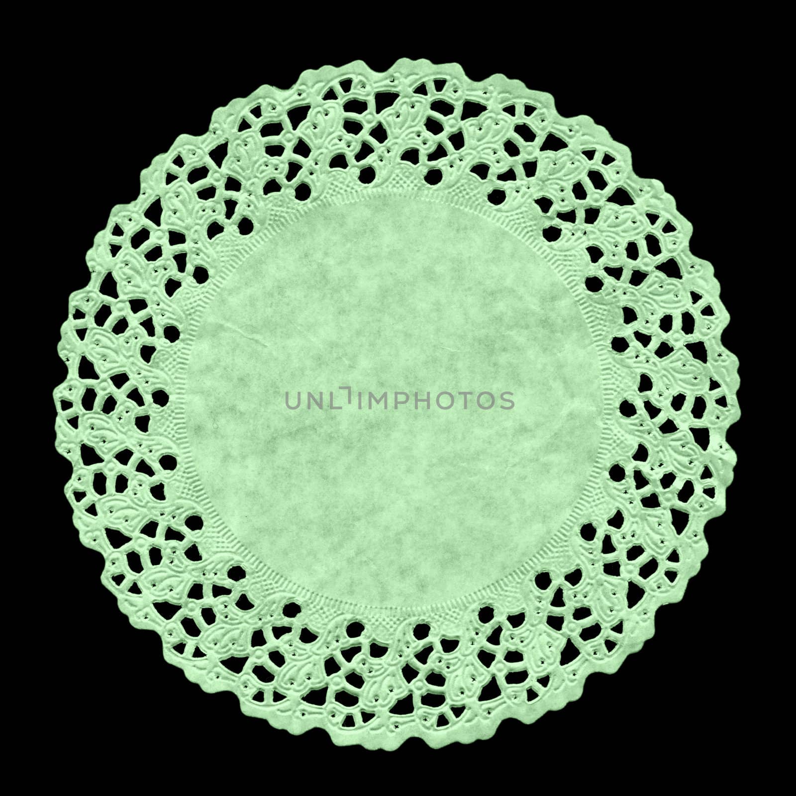 Small circular ornamental doily mat on black background