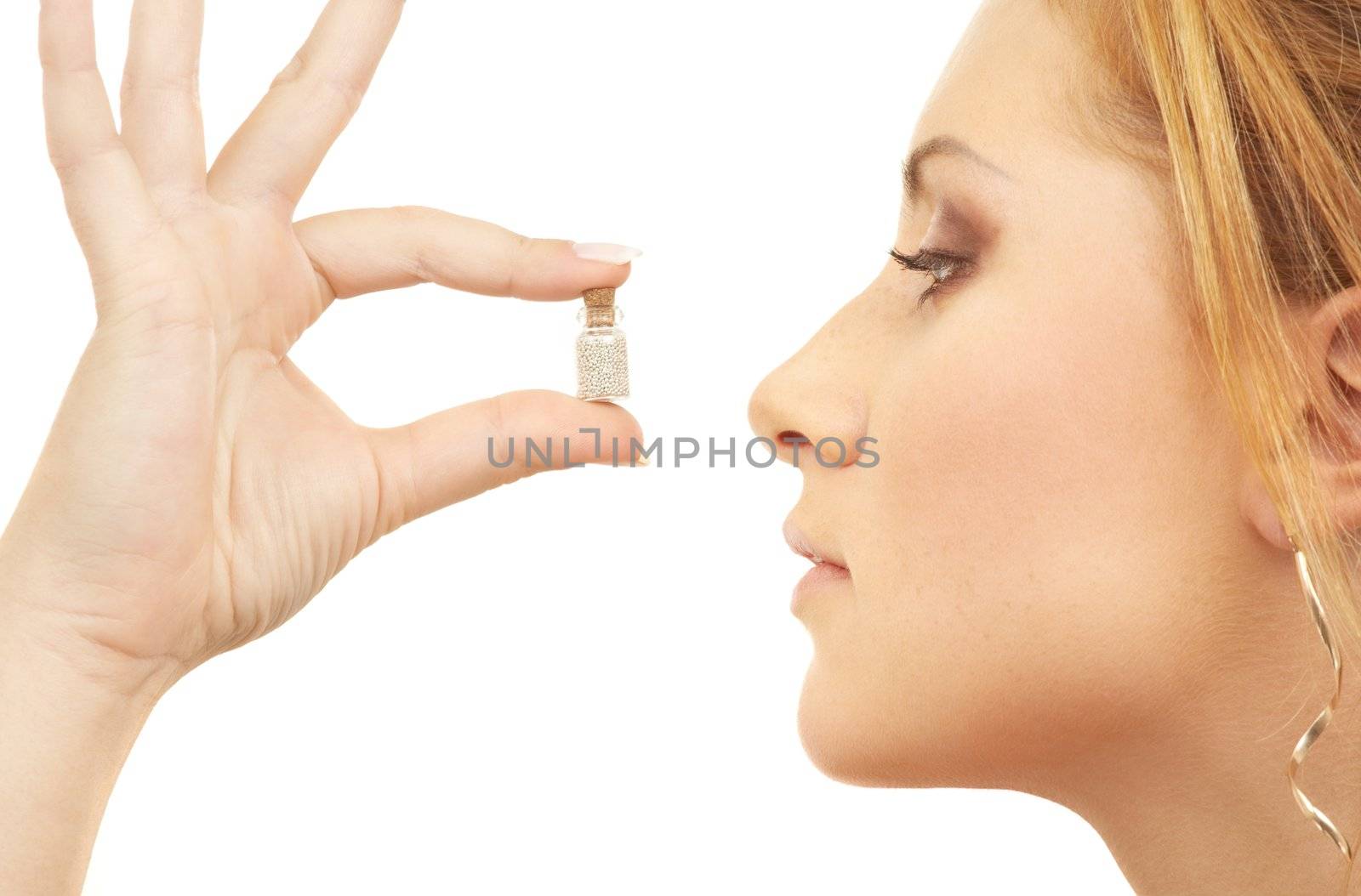 lovely girl holding tiny jar with mysterious potion