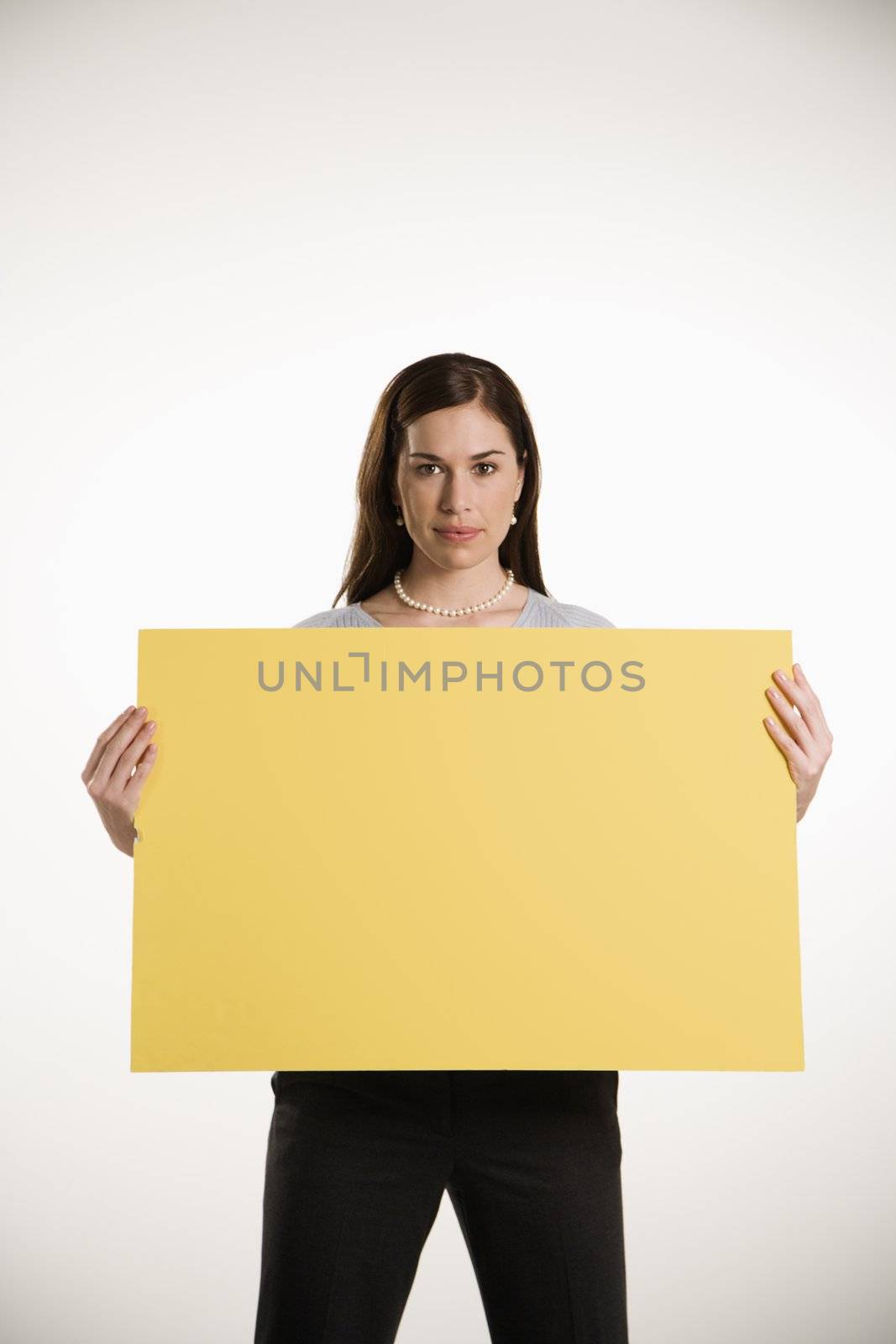 Woman holding blank sign. by iofoto