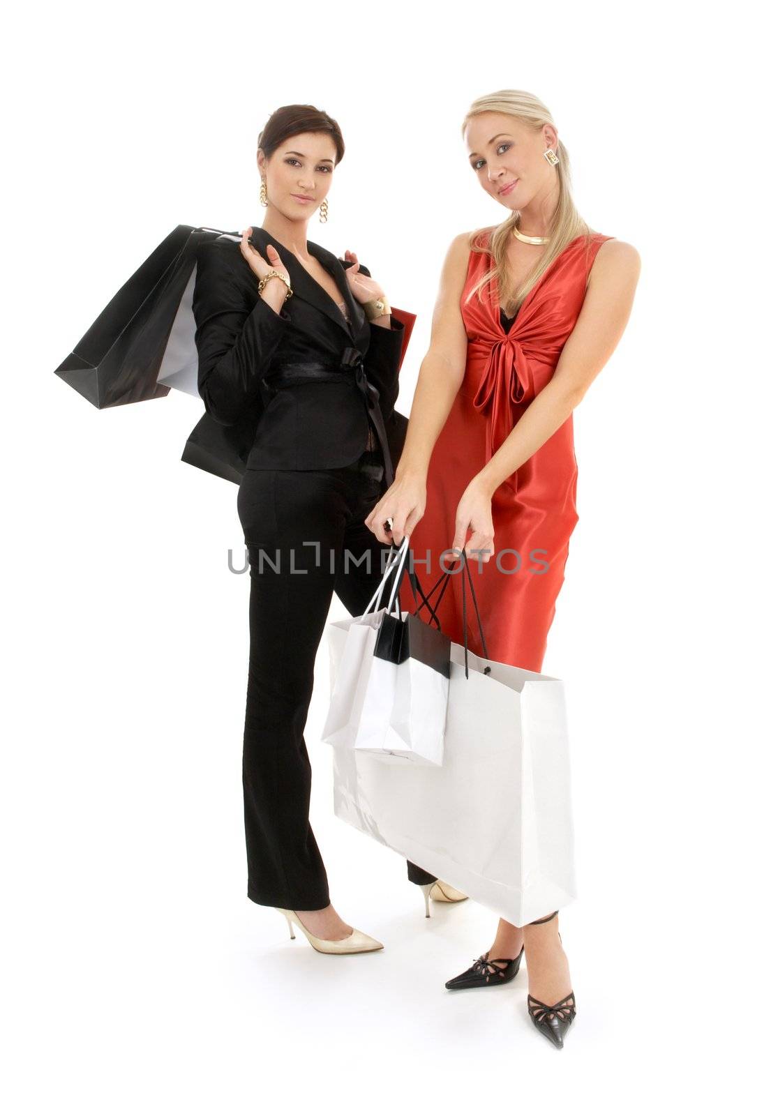 two happy girls with shopping bags over white