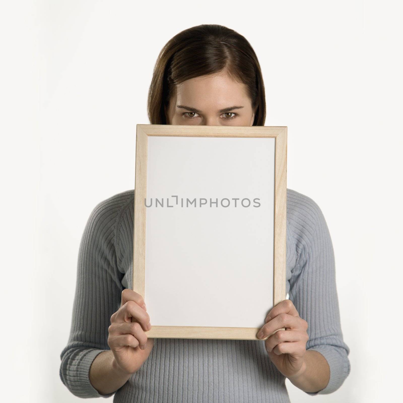 Woman holding blank sign. by iofoto