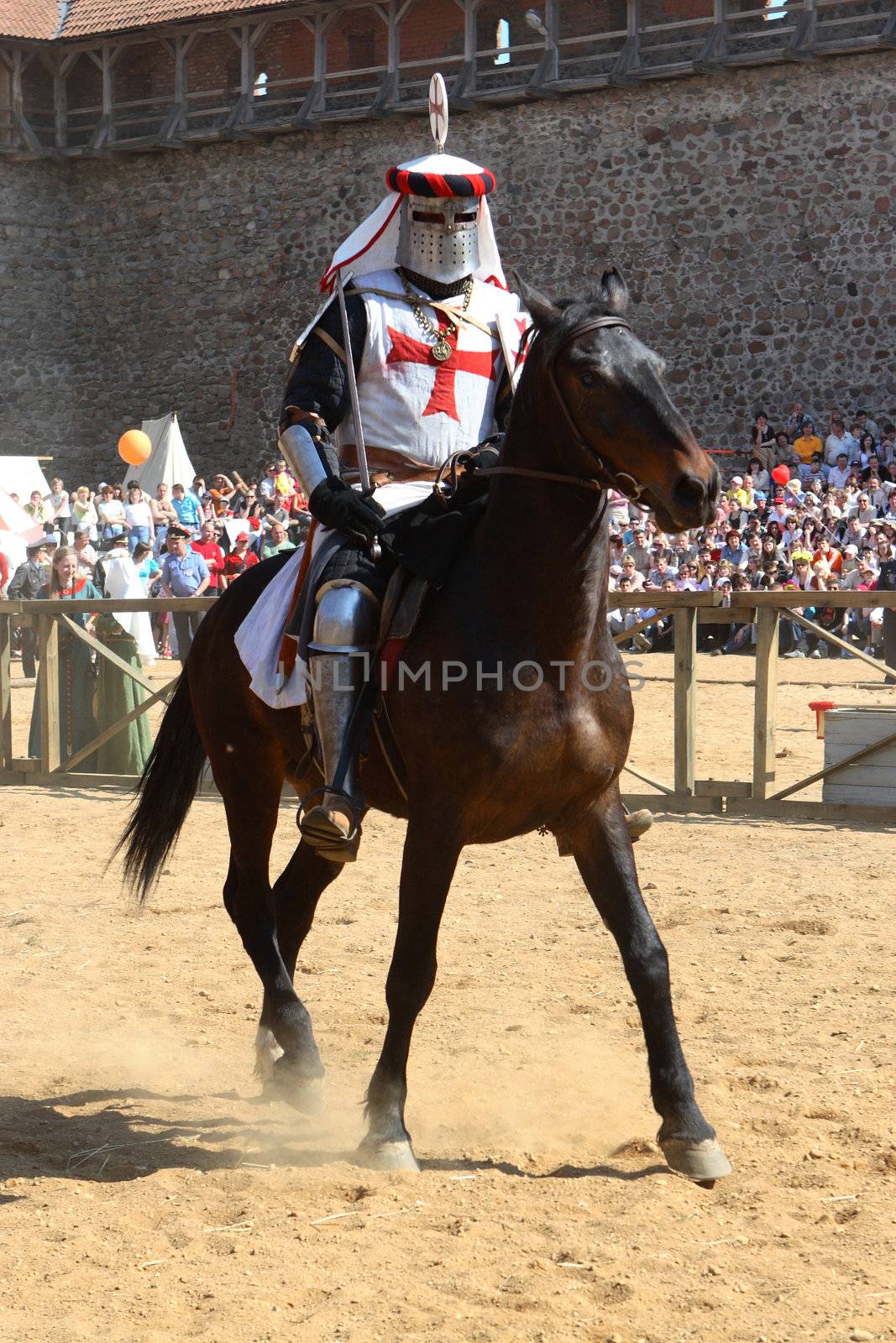 The knight on a horse within the precincts of the lock, on a background spectators