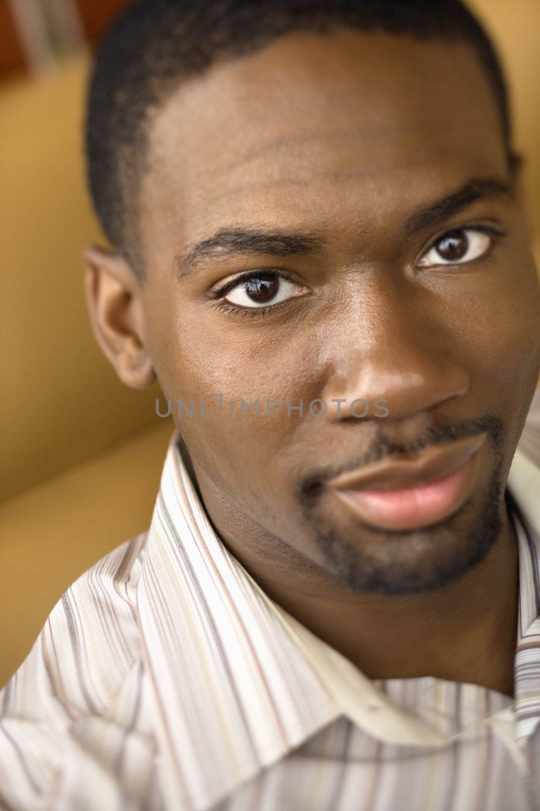 Portrait of African American mid adult man looking at viewer.