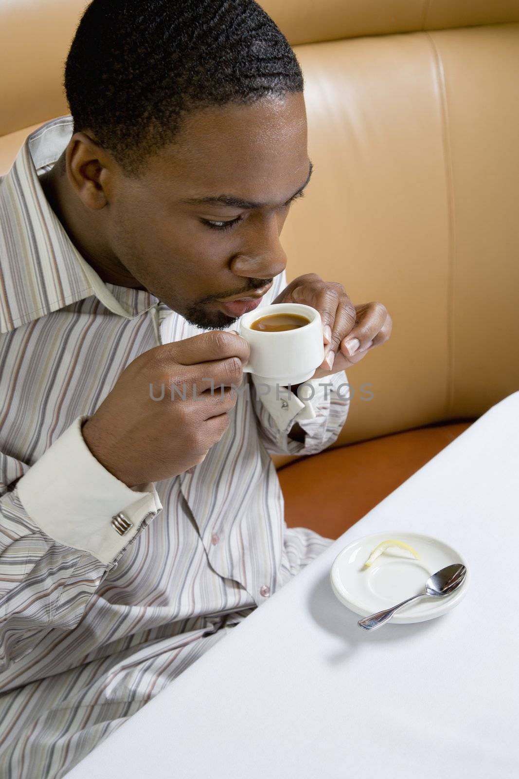 African American mid adult man drinking expresso.