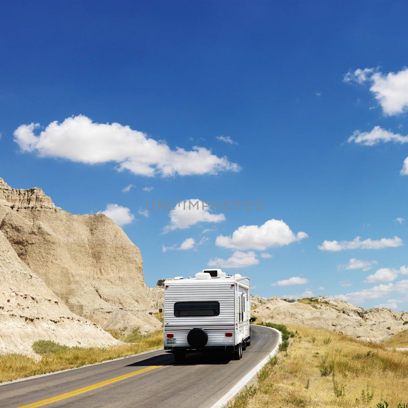 Camper on scenic road. by iofoto