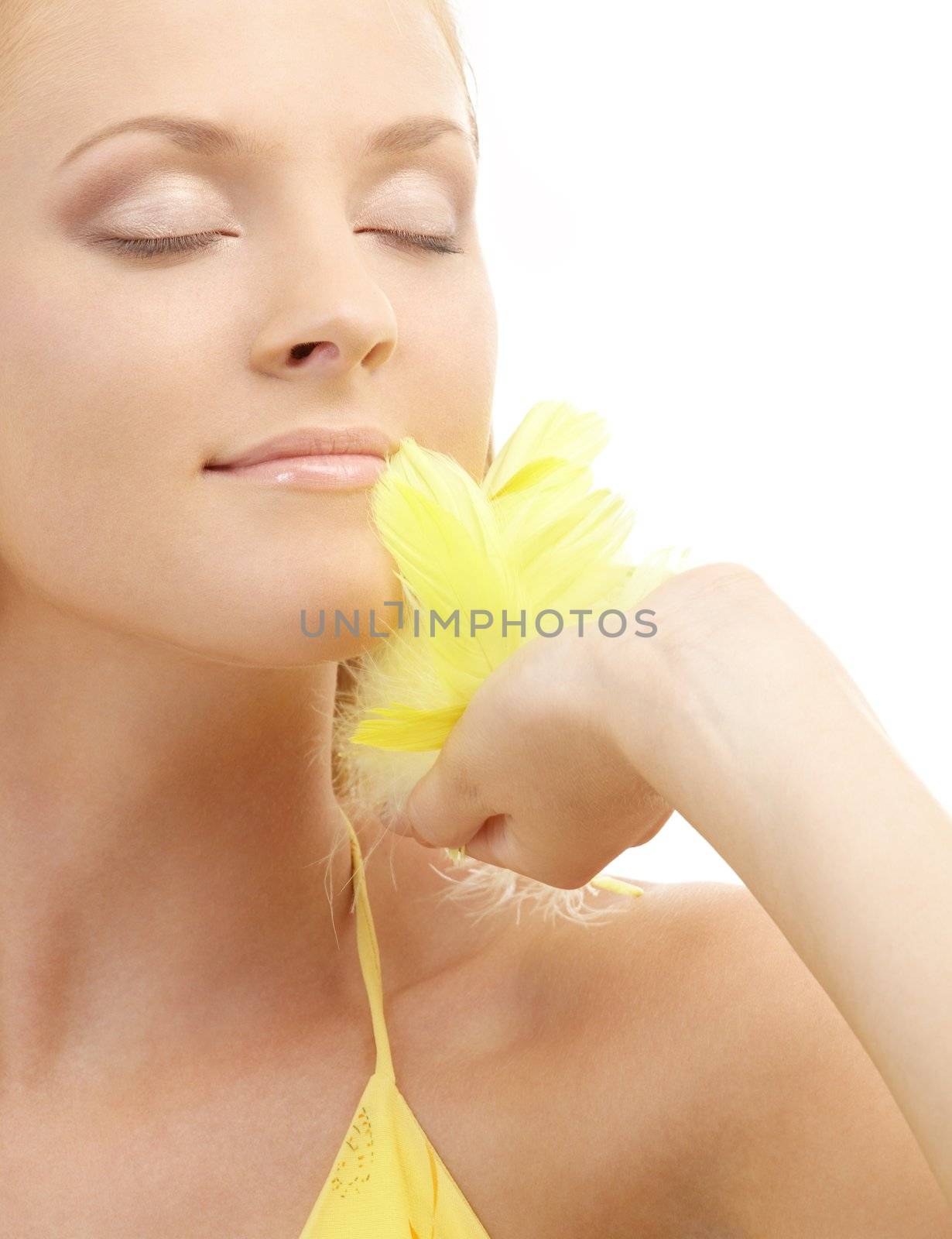 portrait of girl with yellow feathers over white background