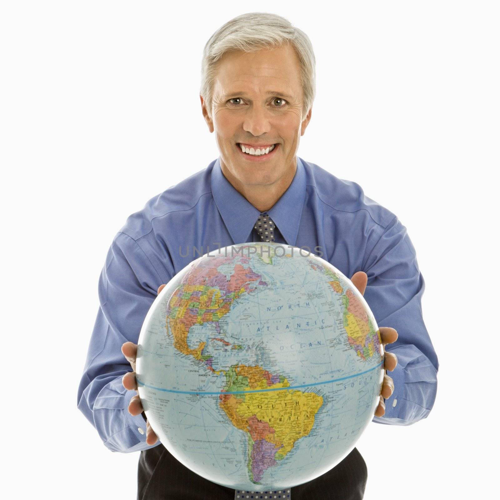 Middle aged Caucasian man holding globe towards viewer.