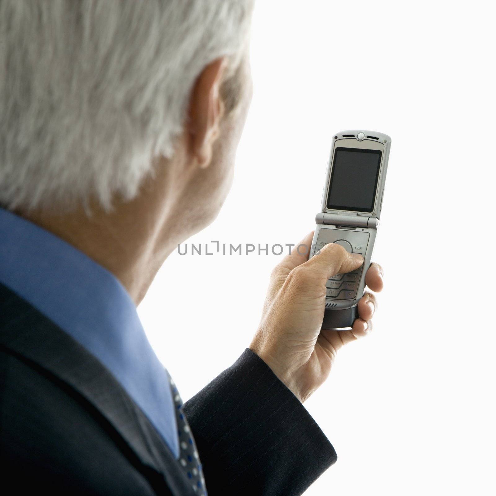 Back view of Caucasian middle aged man looking at cell phone.