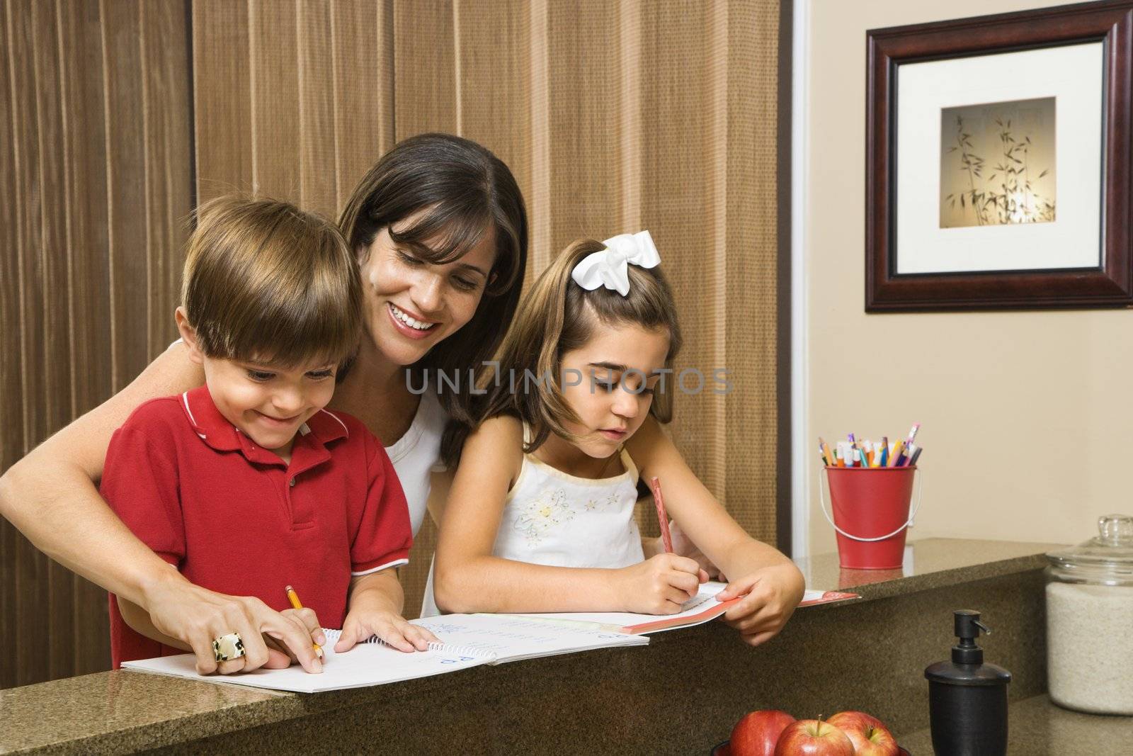 Family doing homework. by iofoto