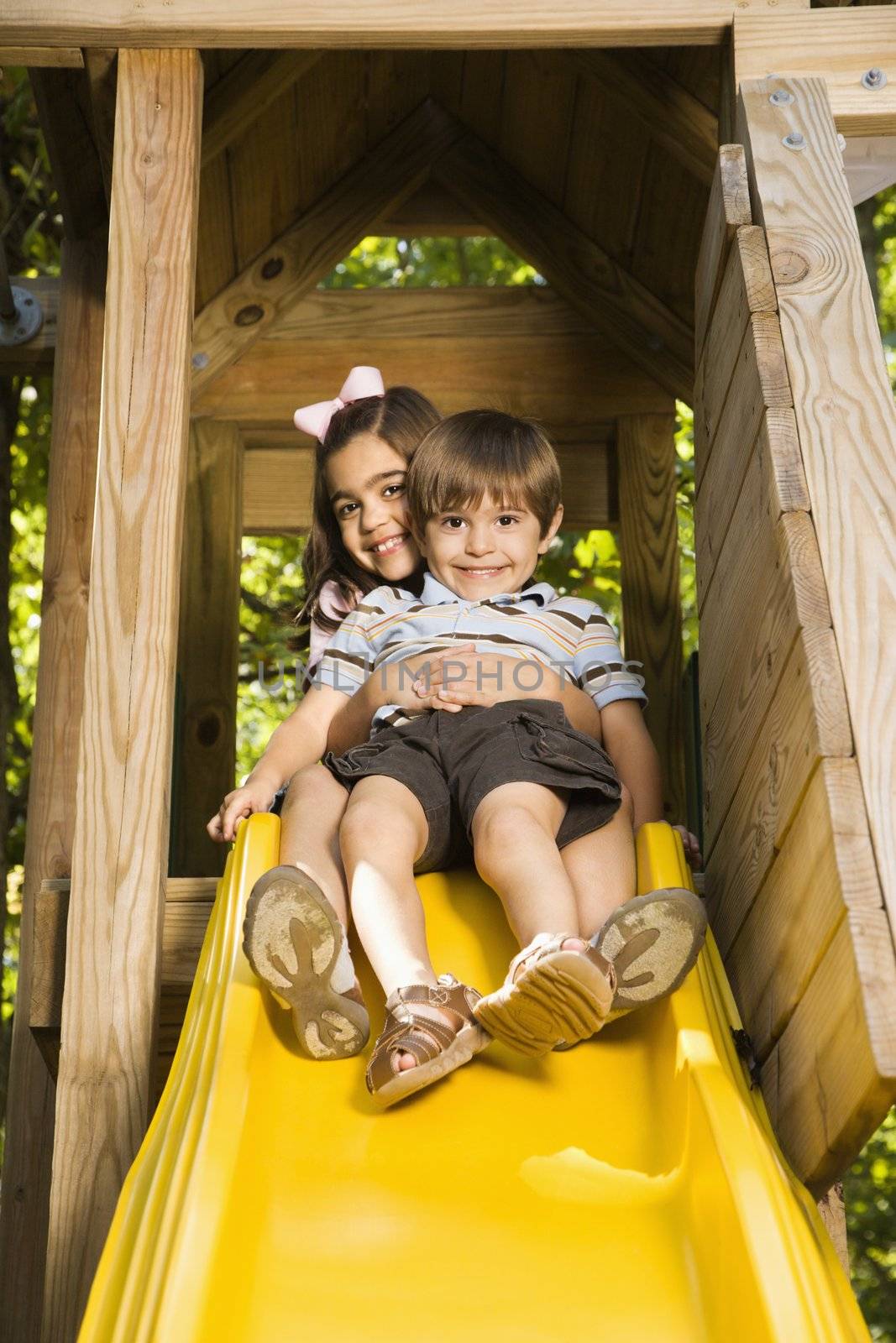 Kids on slide. by iofoto