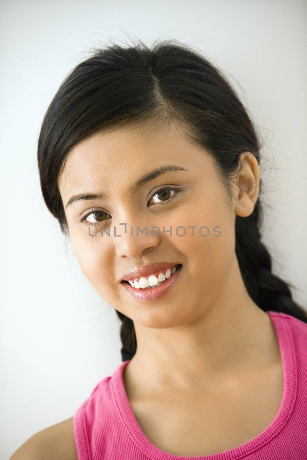 Portrait of smiling young Asian woman.