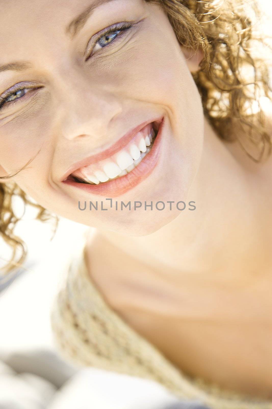 Close-up portrait of smiling Caucasian young adult female.