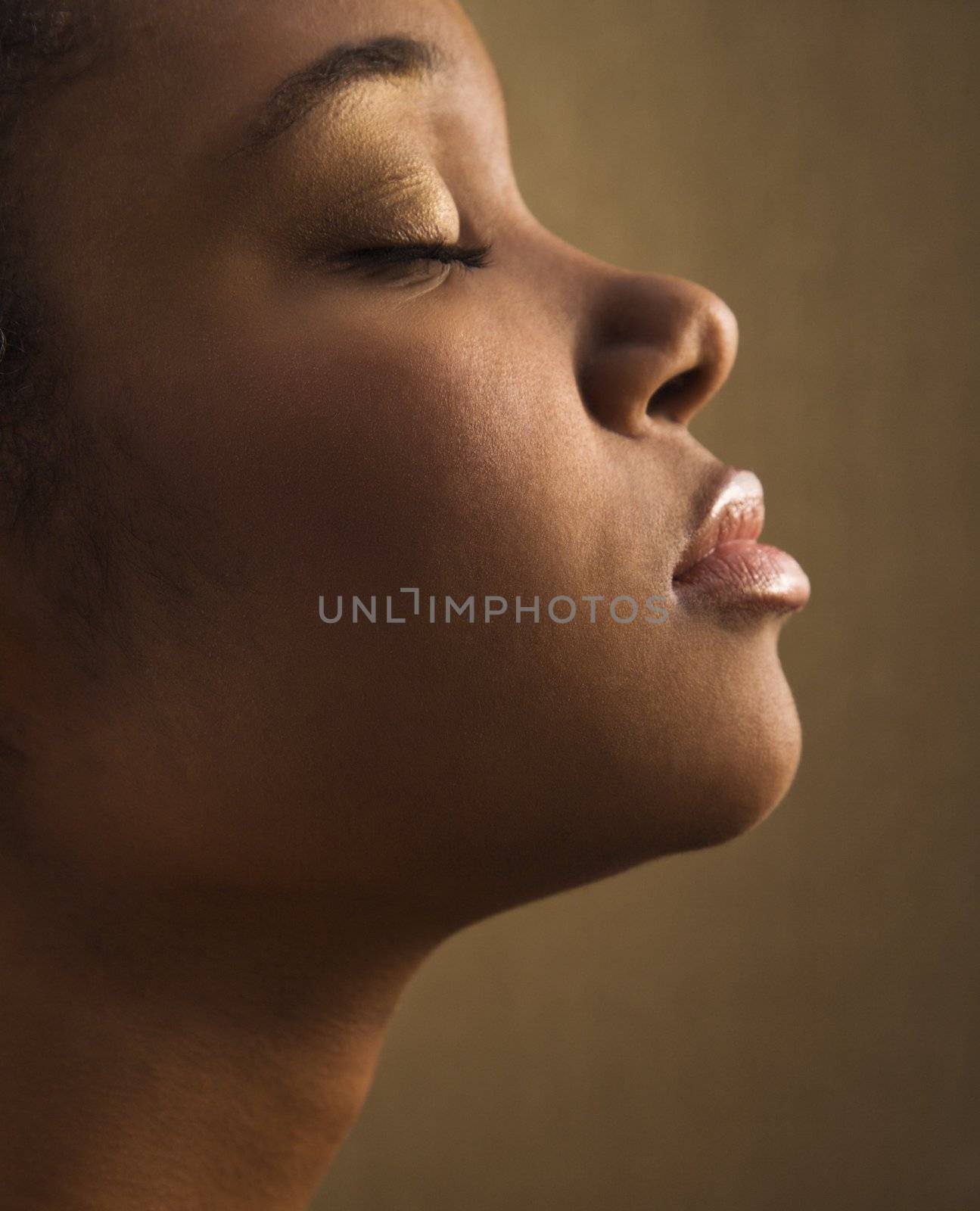 Serene portrait of young adult African-American female's face.