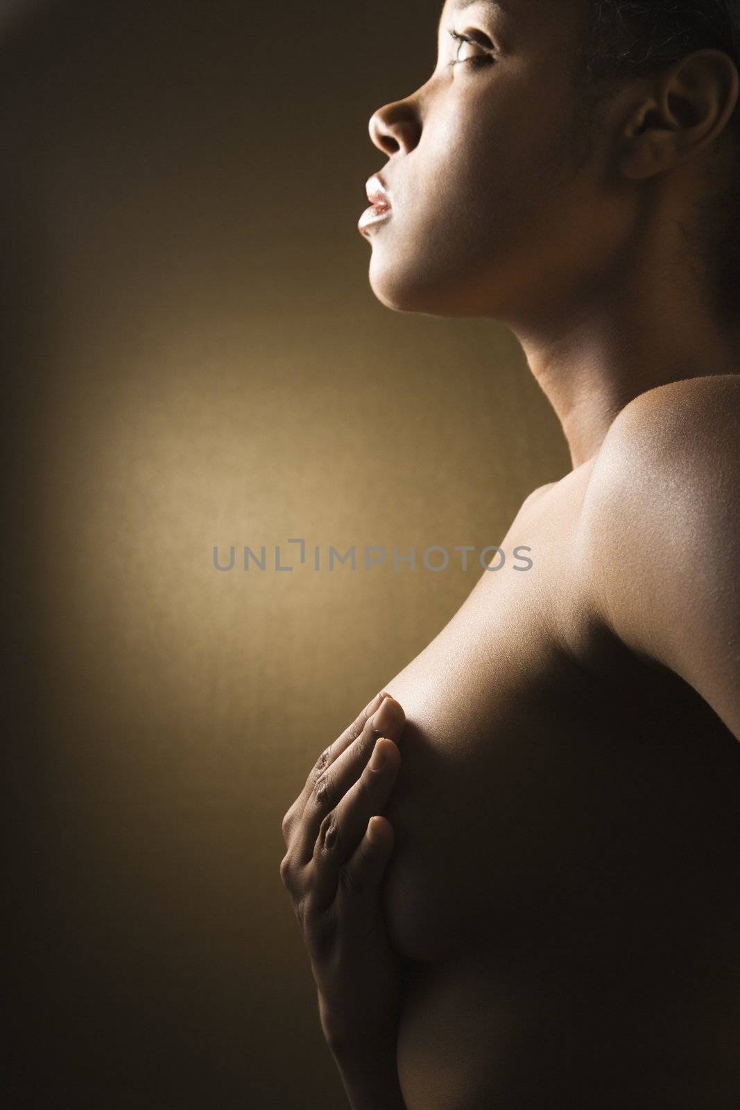Woman with hand on breast. by iofoto