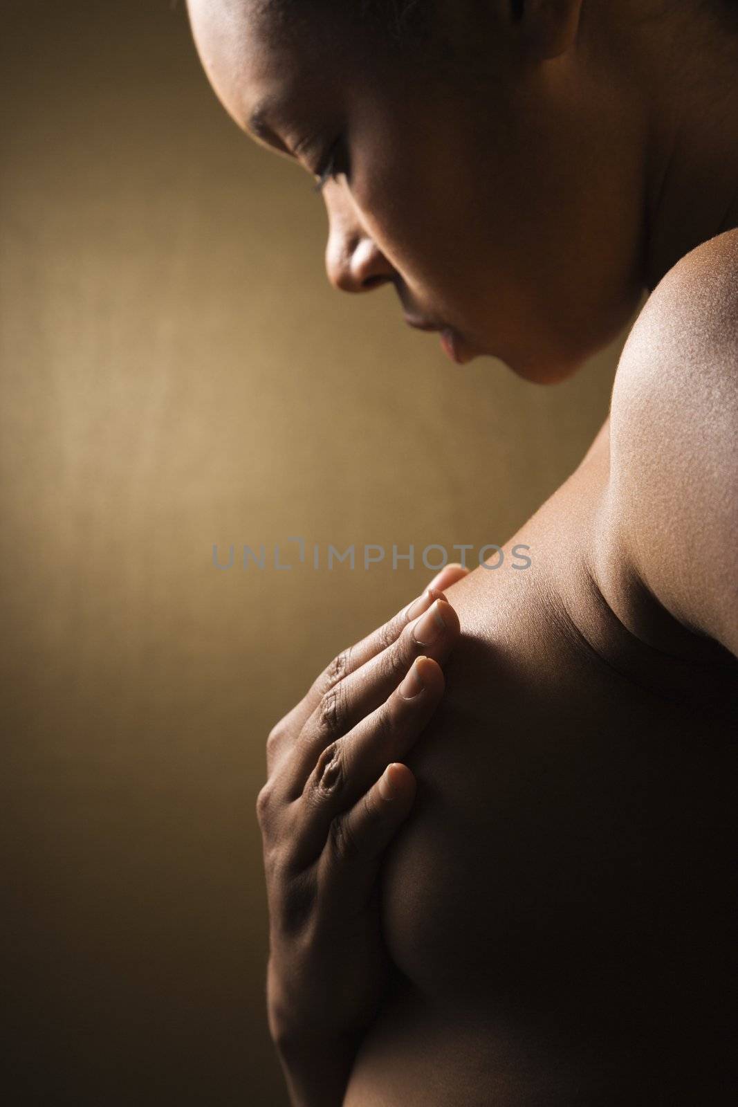 Woman with hand on breast. by iofoto