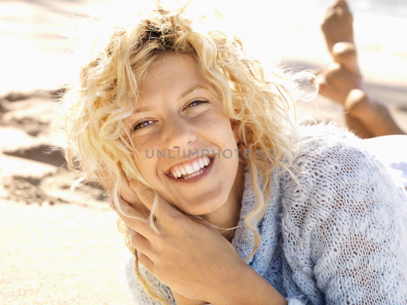 Smiling woman on beach by iofoto