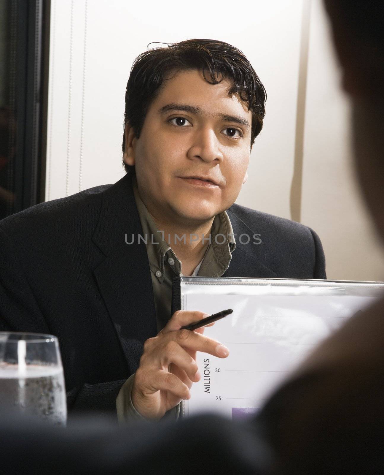 Businessman in meeting with charts.