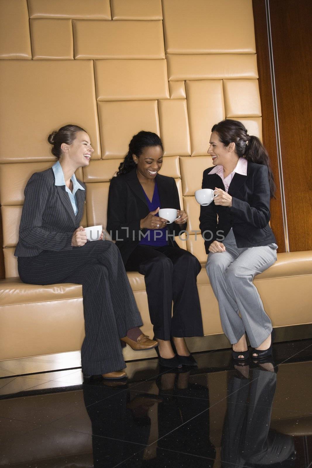 Businesswomen with coffee. by iofoto