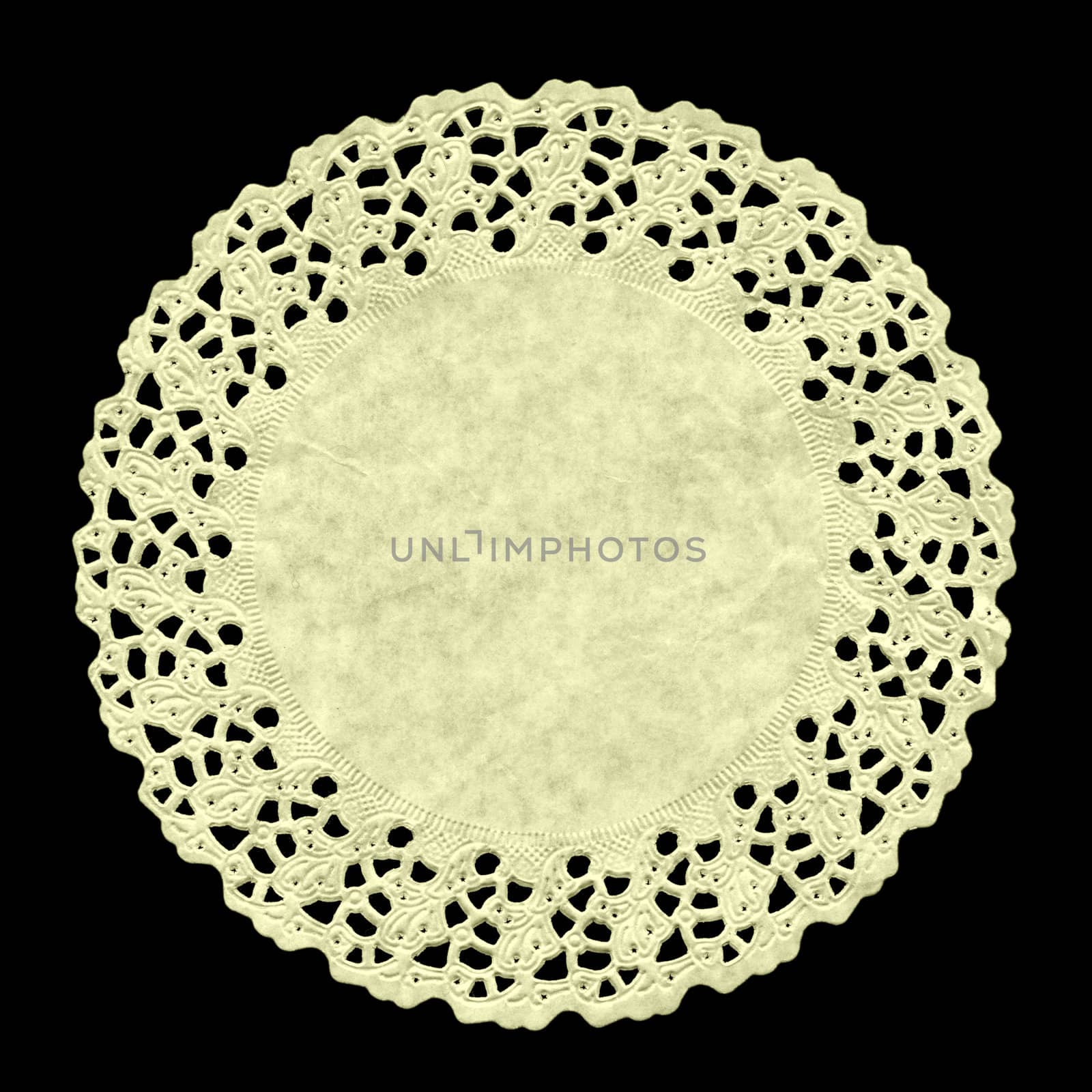 Small circular ornamental doily mat on black background