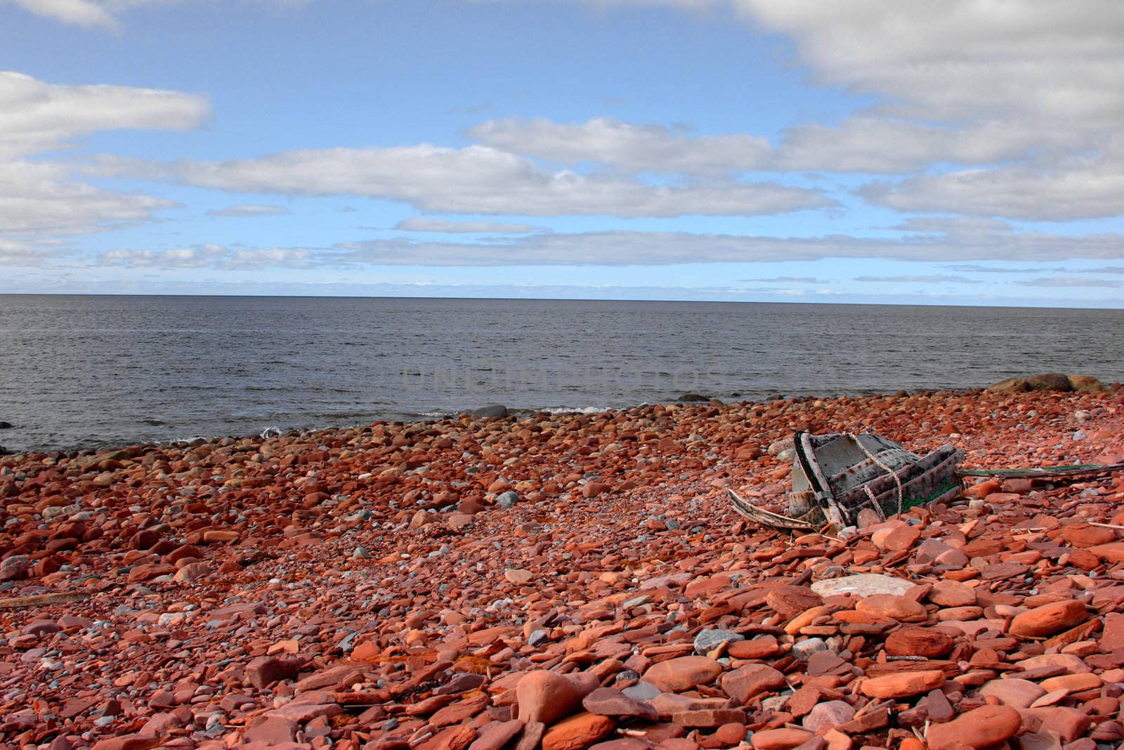 The seacoast covered with red stones
