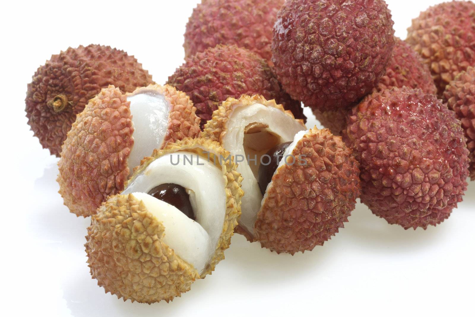 Closeup of fresh litchis over white background