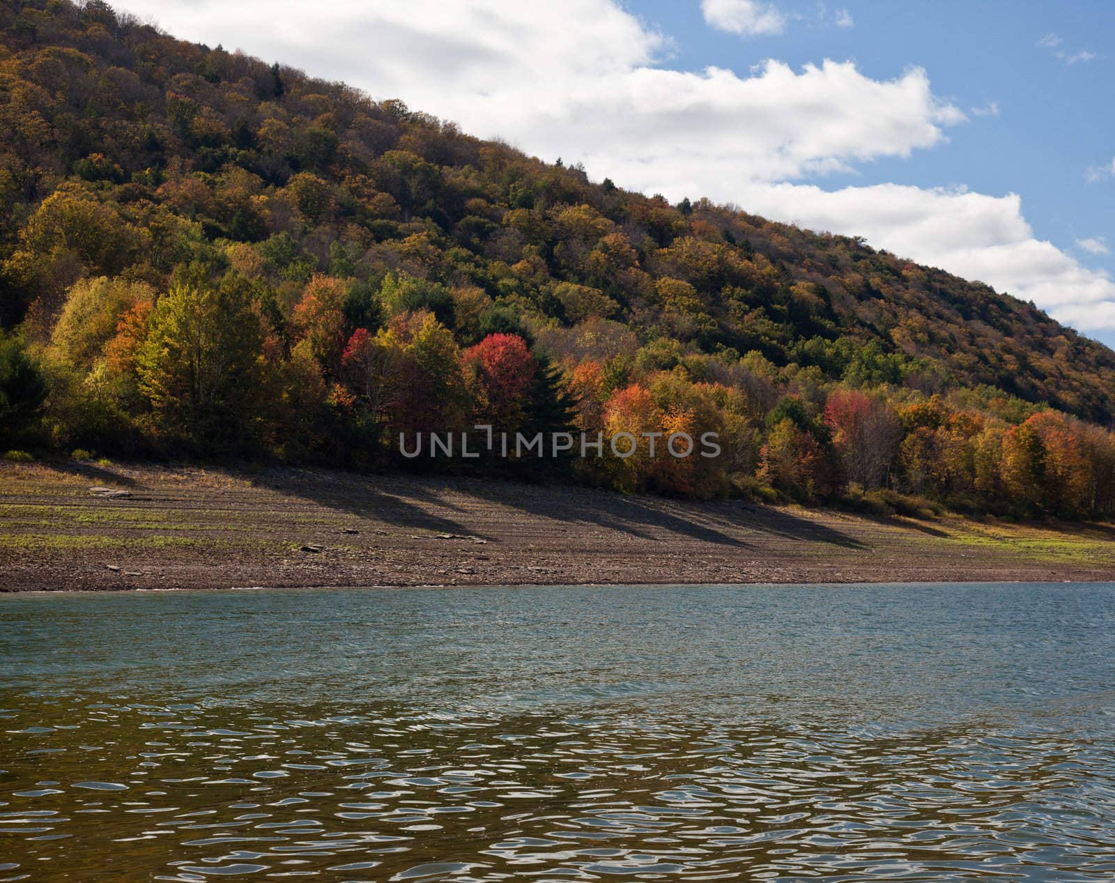 Autumn scene in Vermont as leaves are reflected in calm river