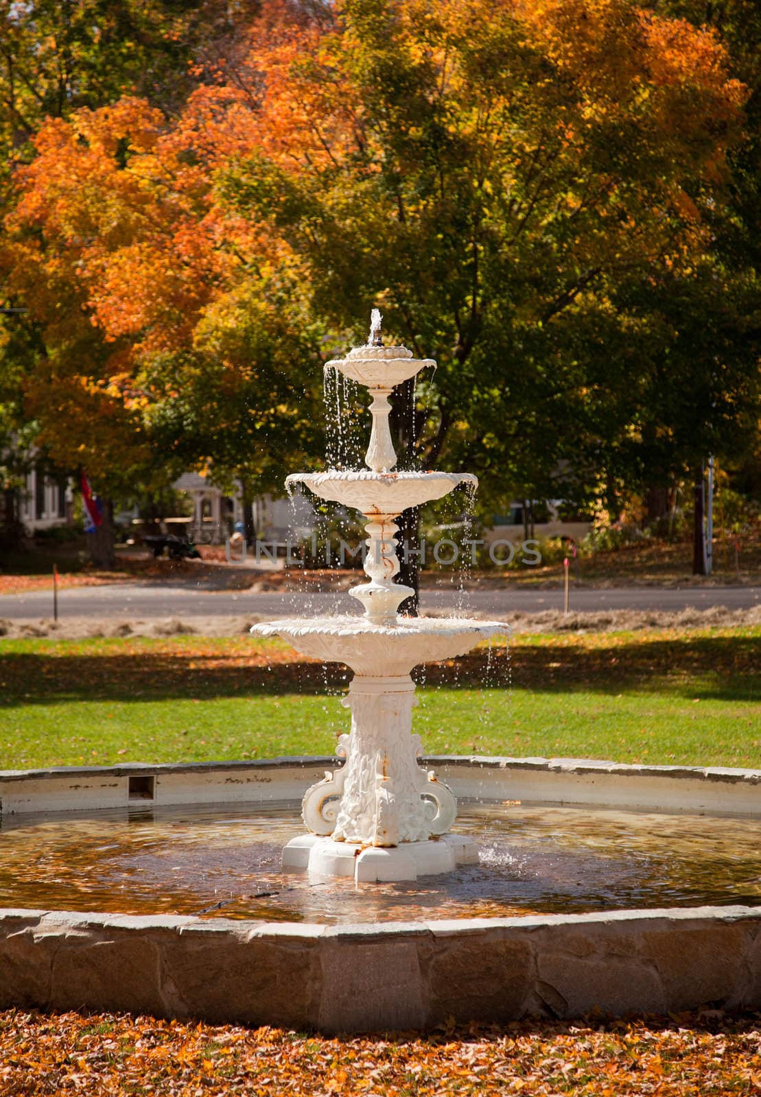 Fall leaves add color to a bright Vermont fountain in Townshend