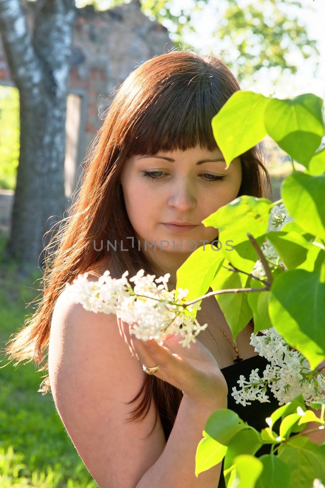 Portrait of young beautiful woman with pipe-tree.
