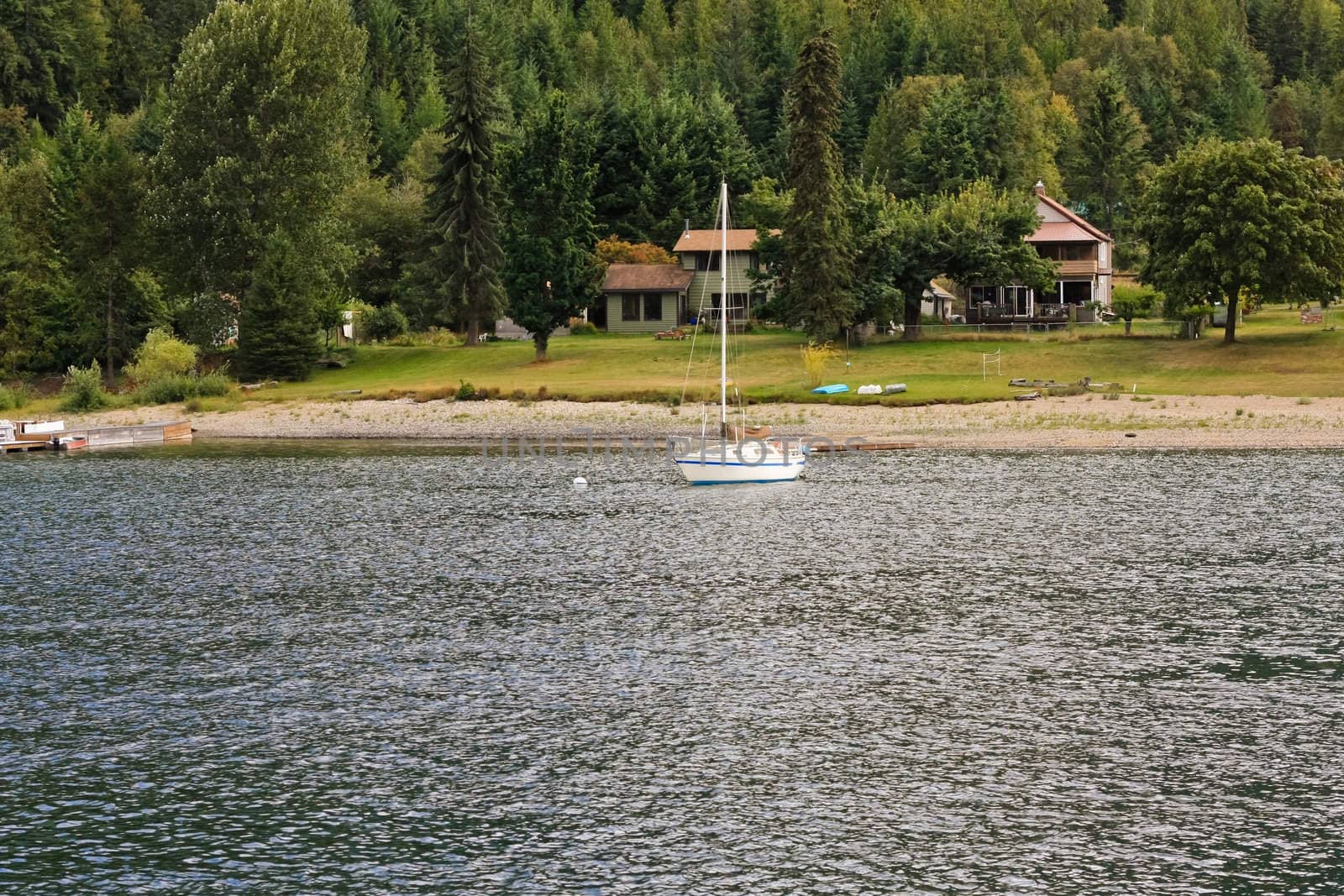 a white yacht parched close to the beach house