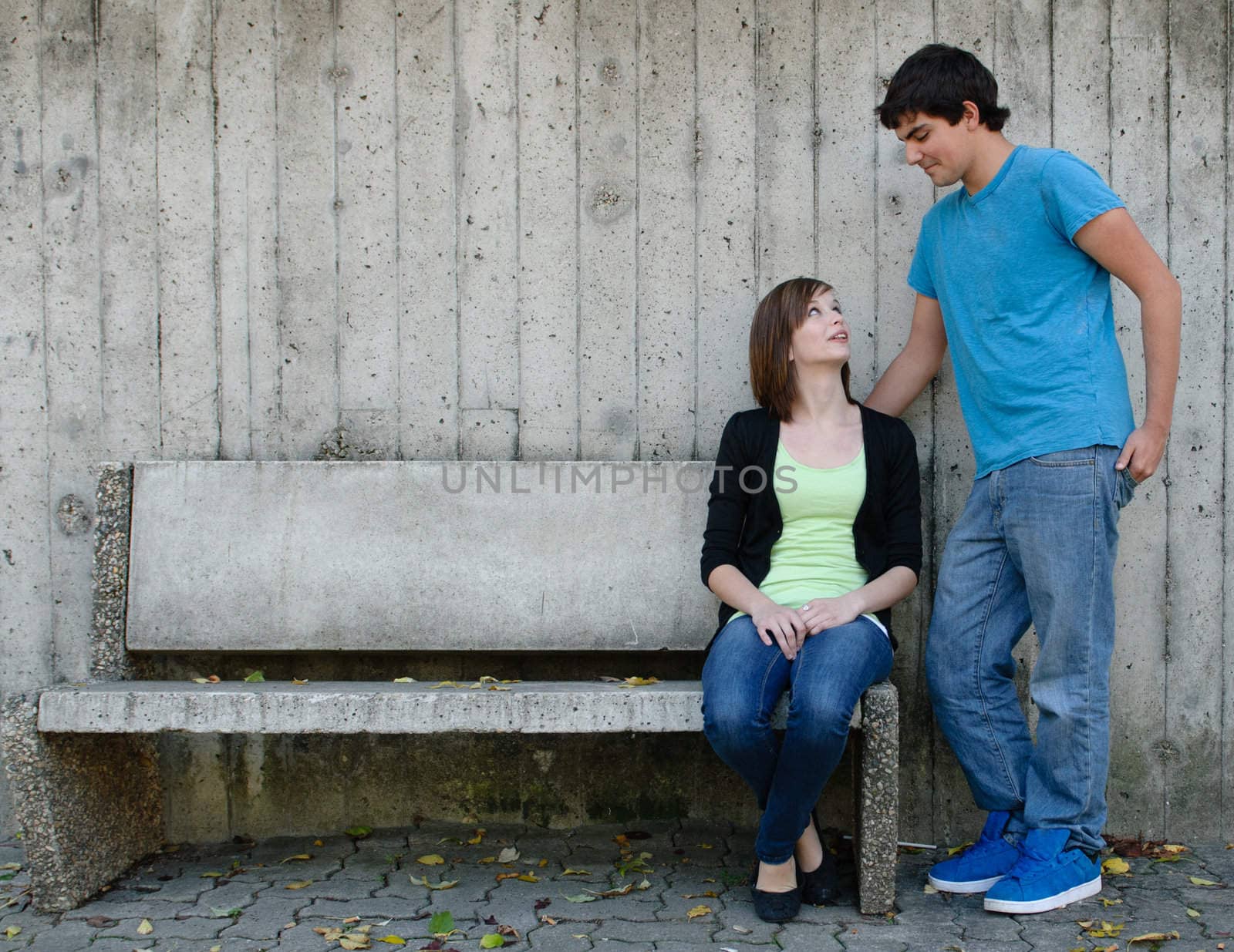 A loving gaze is shared between a teen couple with copyspace on the left
