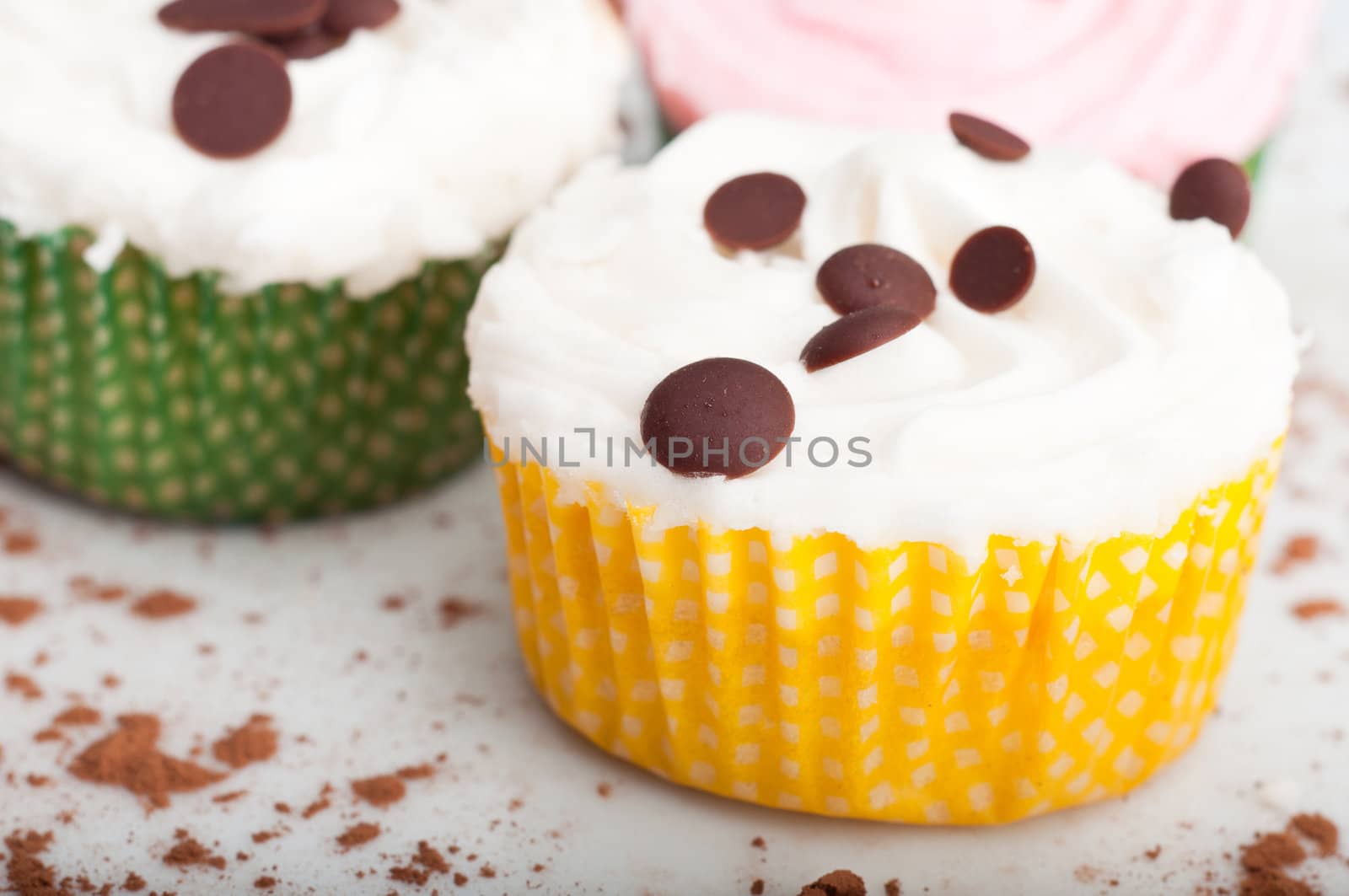 Three delicious cupcakes on a white plate