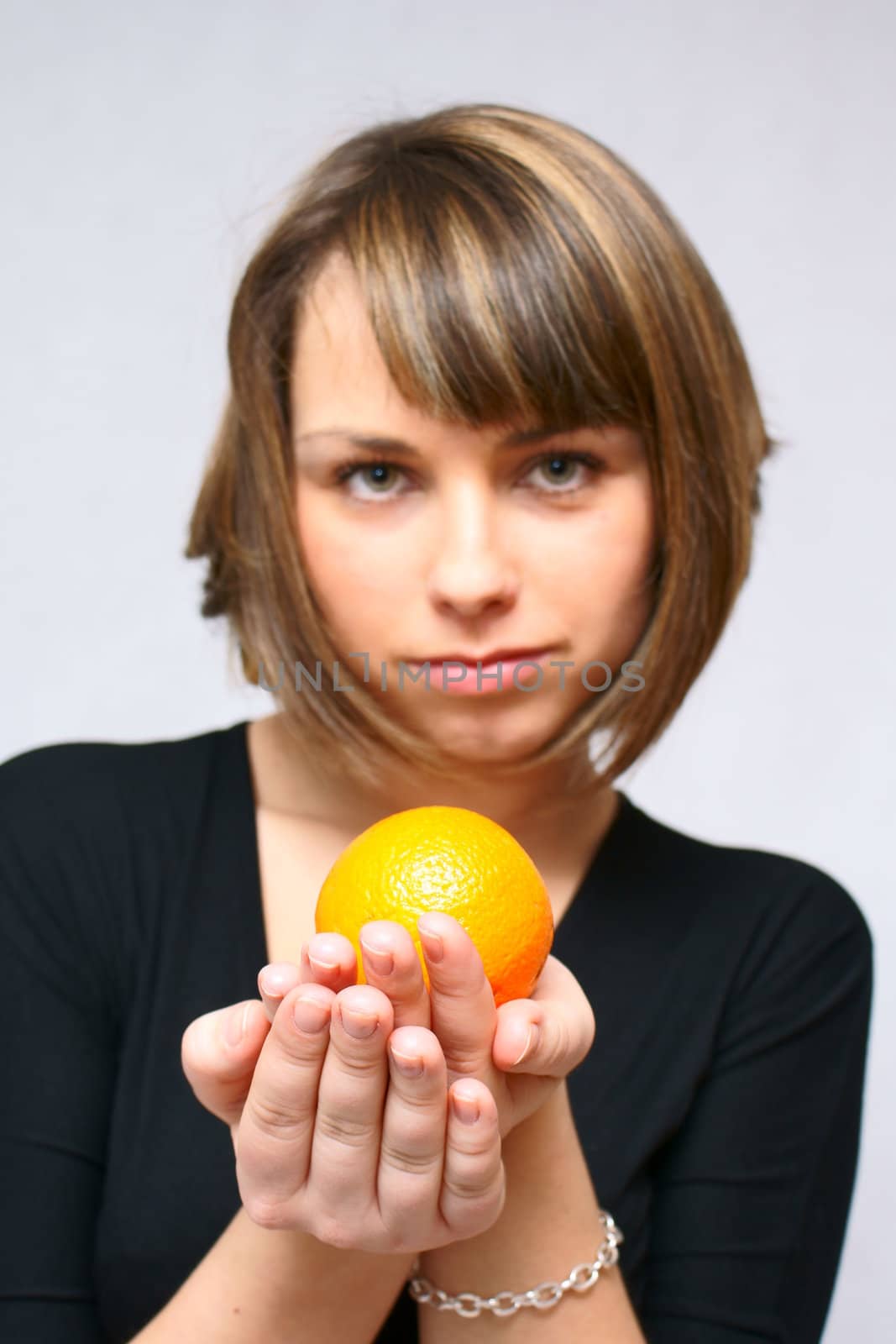 young girl with orange fruit in isolated white background