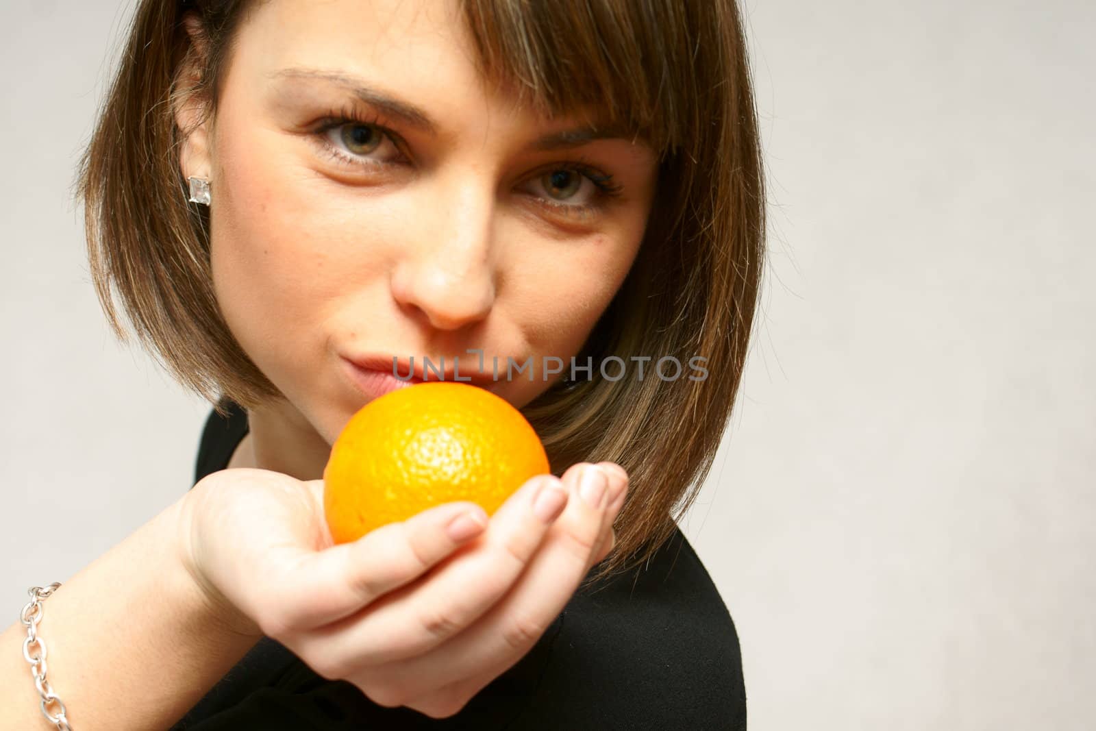 young girl with orange fruit in isolated white background