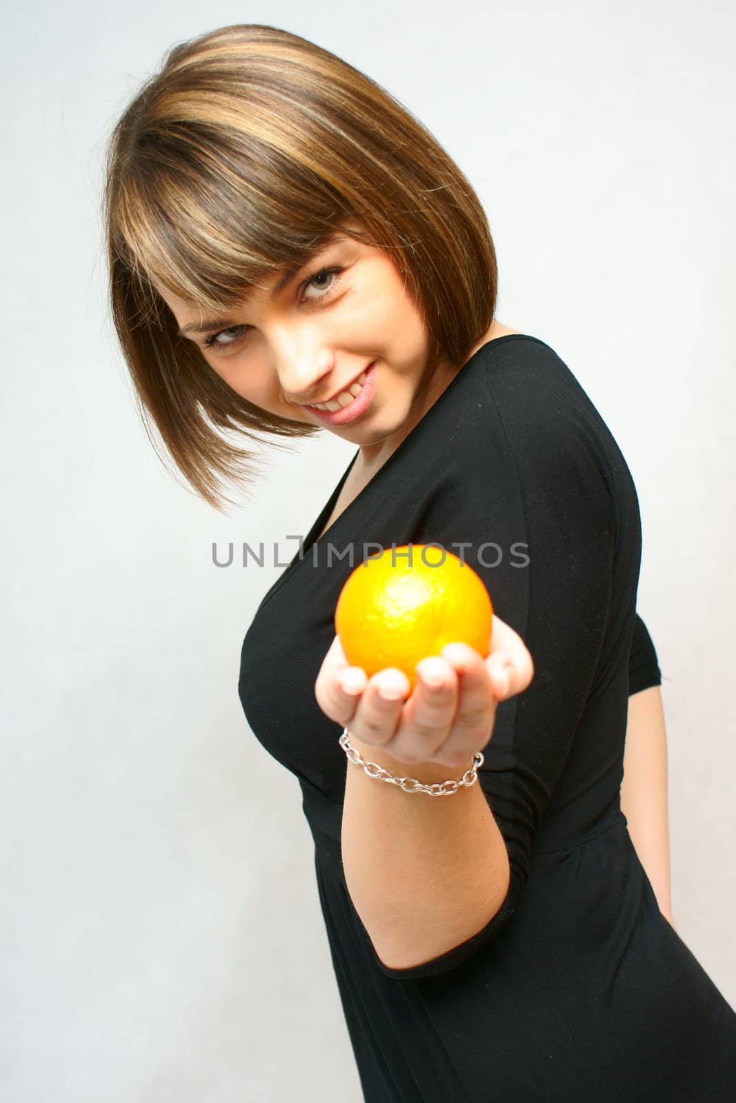 young girl with orange fruit in isolated white background